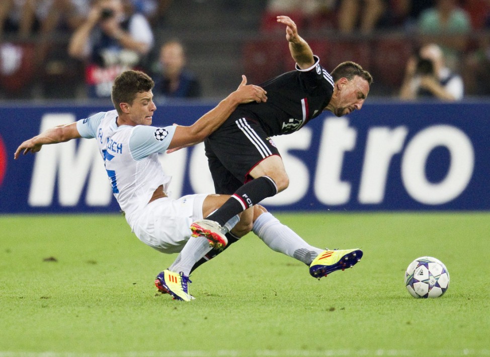 FC Zurich's Koch challenges Ribery of FC Bayern Munich during their Champions League play-off second leg soccer match in Zurich