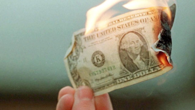 PROTESTER BURNS MONEY AT SEATTLE JAILHOUSE
