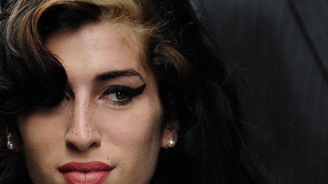File photo of British singer Winehouse arriving at Westminster Magistrates Court in central London