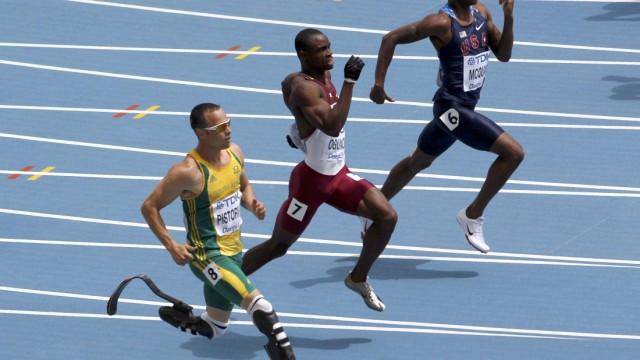 Oscar Pistorius of South Africa runs to the finish line next to Femi Ogunode of Qatar and Tony McQuay of the U.S. in Daegu