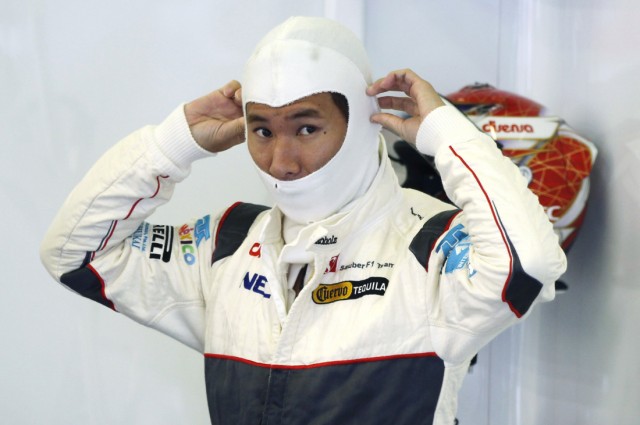 Sauber Formula One driver Kobayashi of Japan stands in the pit during the third practice session of the Belgian F1 Grand Prix
