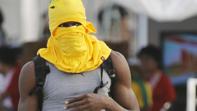 Bolt of Jamaica covers his head with a shirt during a training session at the IAAF World Championships in Daegu