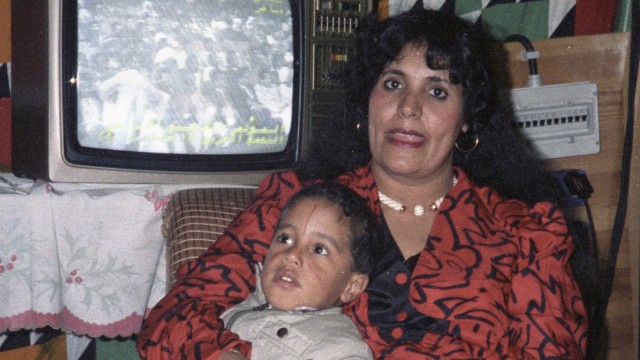 File photo of Safia Gaddafi, wife of Libyan leader Muammar Gaddafi, with one of her children in her Bedouin tent at the Bab-Assaria barracks