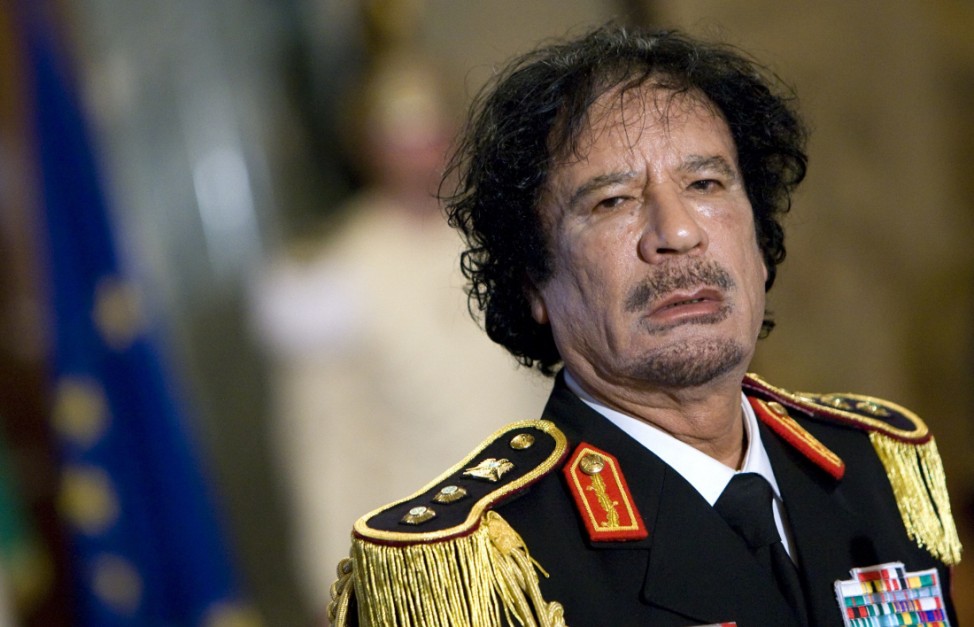 File photo of Libya's leader Gaddafi looking on during a news conference in Rome