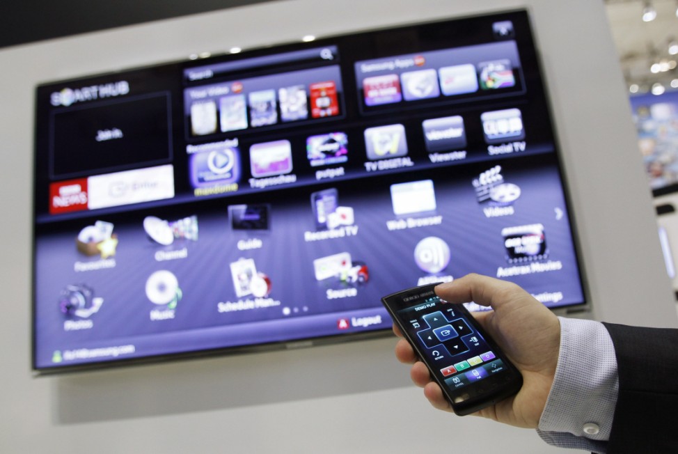 Exhibitor demonstrates a Samsung Smart TV that can be operated with a smart phone before the opening of the IFA consumer electronics fair in Berlin