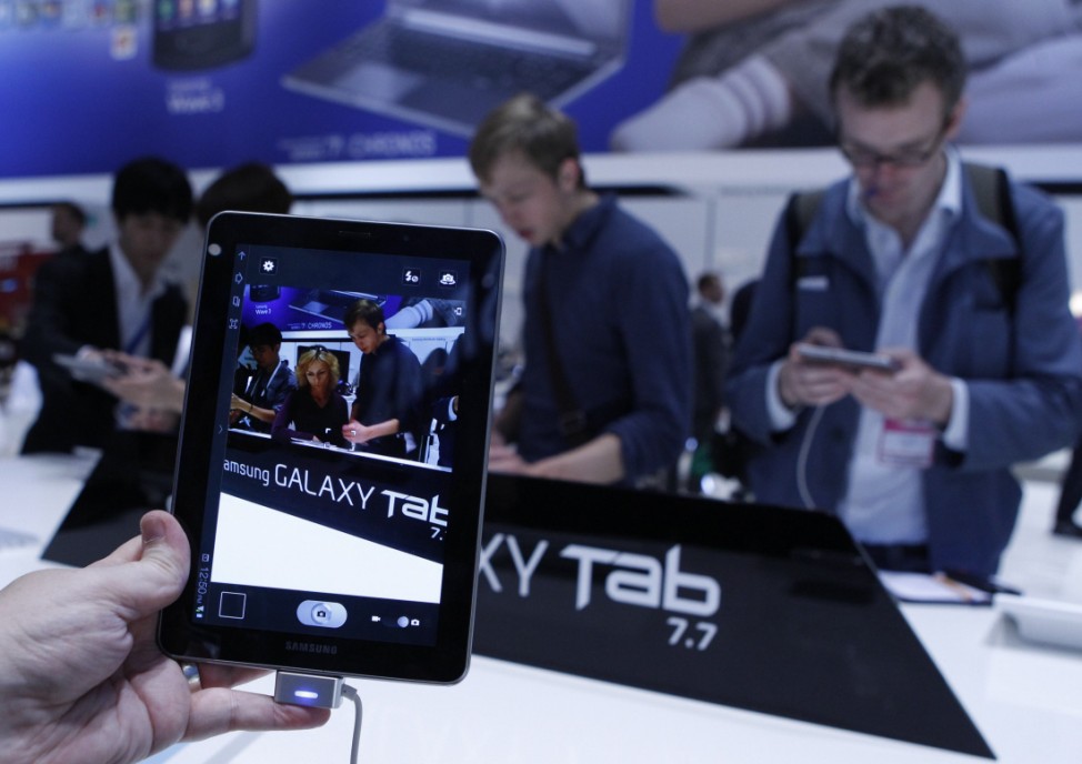 Man holds a Samsung Galaxy Tab 7.7 during press day at IFA consumer electronics fair in Berlin