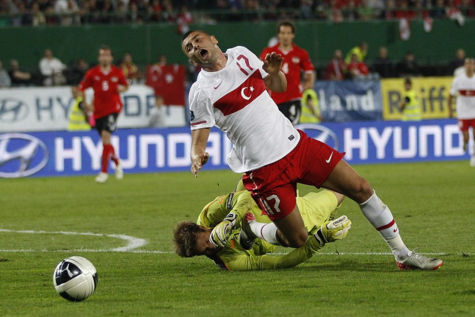Austria's Gruenwald and Turkey's Ylmaz fight for the ball during their Euro 2012 Group A qualifying soccer match in Vienna