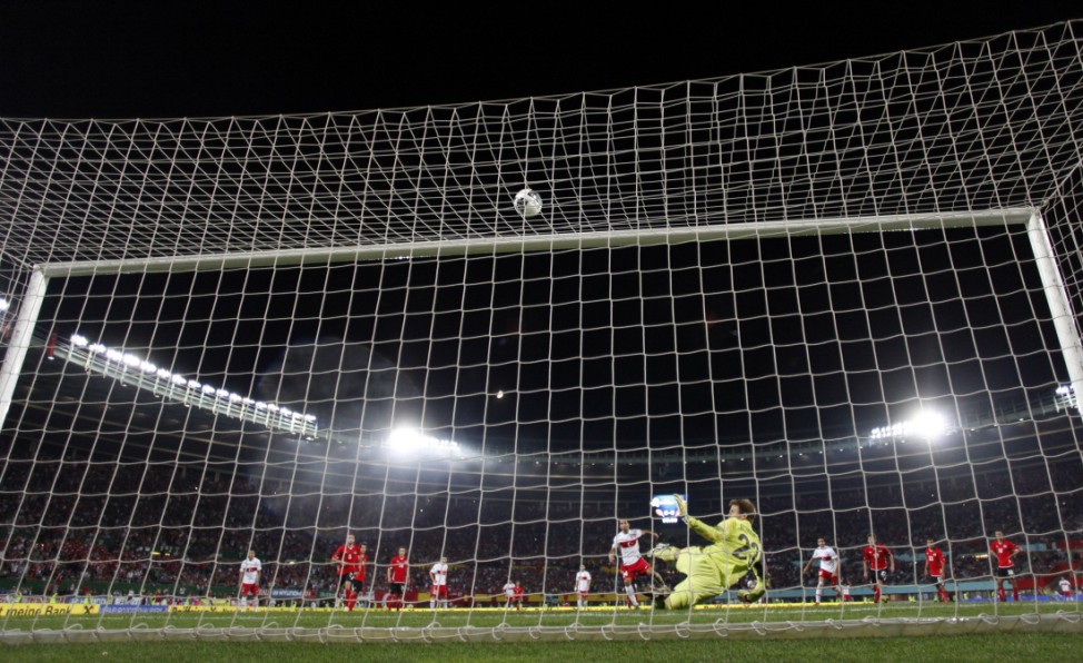 Austria's goalkeeper Gruenwald  saves a penalty shot by Turkey's Turan during their Euro 2012 Group A qualifying soccer match against Turkey in Vienna