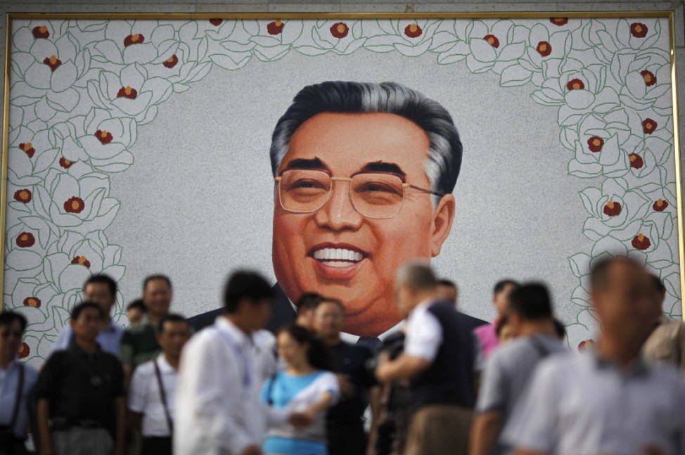 Chinese tourists visit to a portrait of North Korean leader Kim Il-sung in Rajin