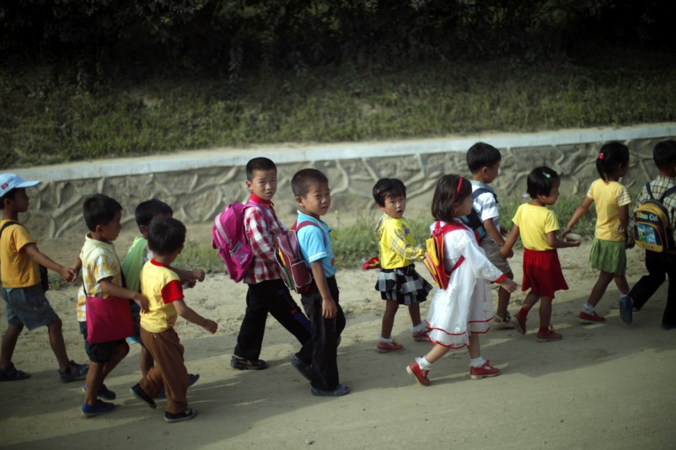 Children walk home after school at in a rural area near the North Korean special economic zone of Razon