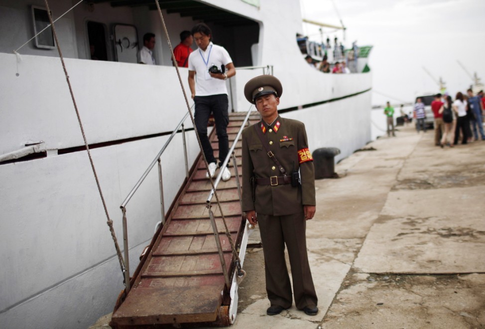 A soldier stands before the departure of the Mangyongbyong cruise ship at the North Korean especial economic zone of Razon City