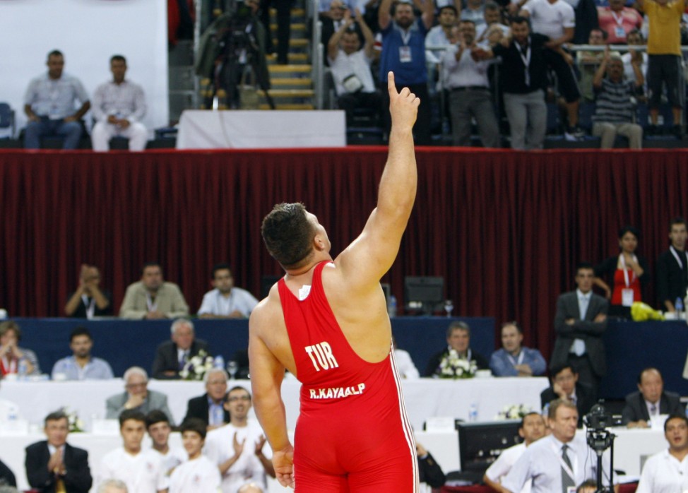 Turkey's Kayaalp celebrates after winning the gold medal against Cuba's Lopez Nunez after their Greco Roman 120 kg gold medal match at the Senior Wrestling World Championship in Istanbul