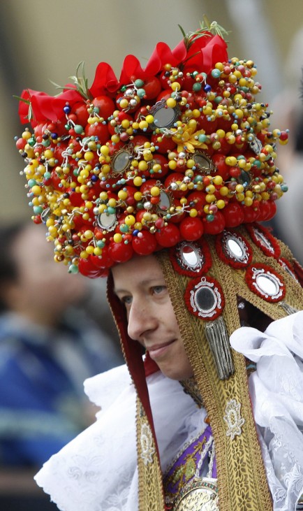 Woman in traditional costume takes part at Oktoberfest parade in Munich