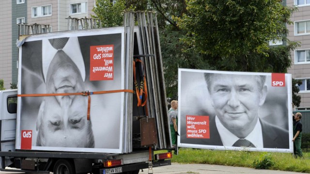 Workers remove election placards of Berlin's Social Democratic mayor Klaus Wowereit in Berlin.