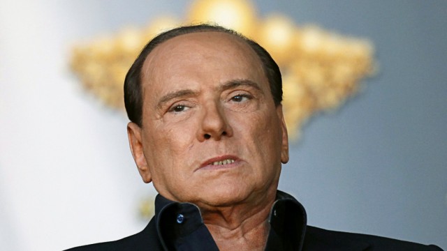Italy's Prime Minister Berlusconi looks on as he attends the Atreju political meeting in Rome
