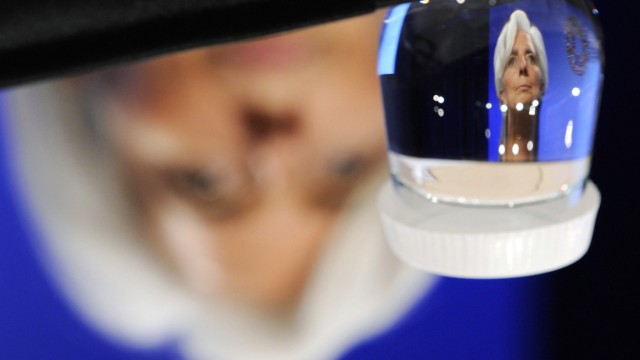 IMF Managing Director Lagarde is reflected in a glass of water during a Development Committee news conference at the IMF-World Bank Annual Meetings in Washington