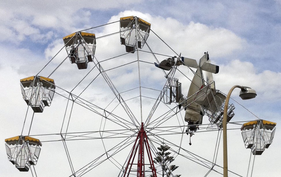 Children trapped on a ferris wheel are seen after an ultra-light plane crashed into it at a fair near Taree