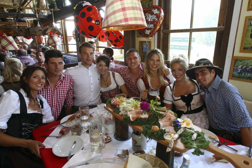 FC Bayern Munich players and their partners pose during a visit at Oktoberfest in Munich