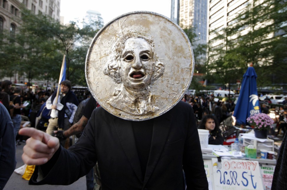 A member of the Occupy Wall St movement, Noah Fischer, shouts his protests against income inequality while demonstrating in the financial district of New York