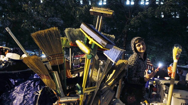 An Occupy Wall Street campaign demonstrator stands near cleaning supplies in Zuccotti Park