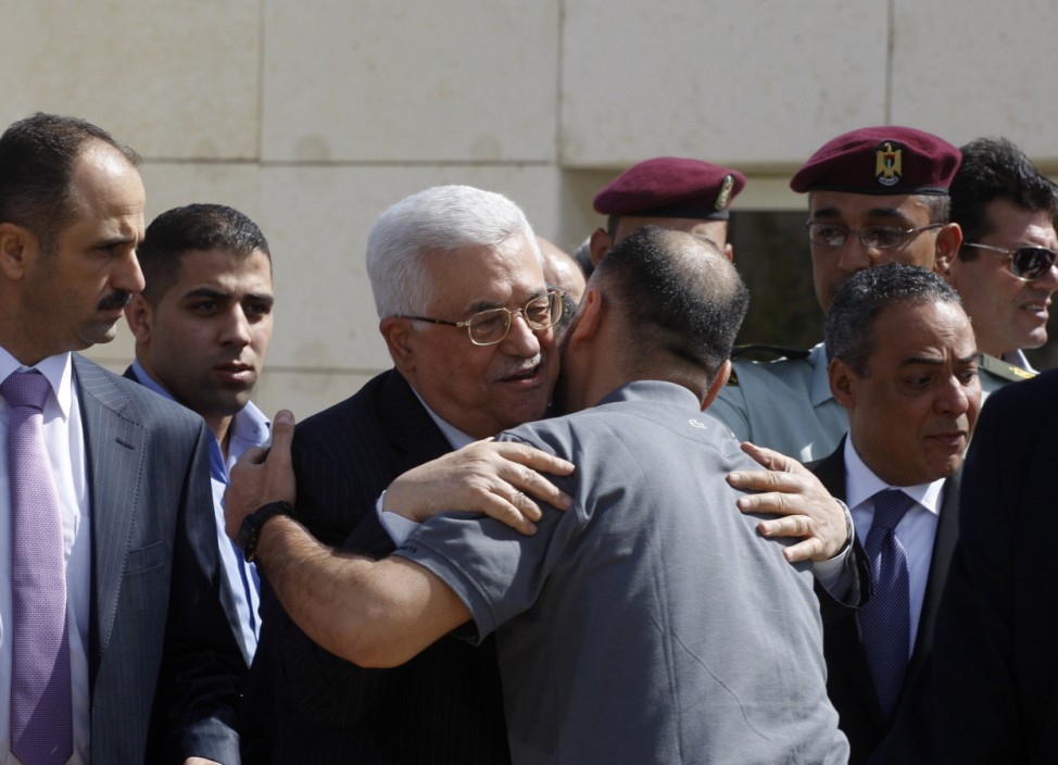 Palestinian President Abbas greets a newly released Palestinian prisoner during a welcoming ceremony in Ramallah