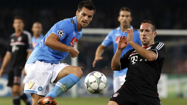 Napoli's Christian Maggio challenges Frank Ribery of Bayern Munich during their Champions League Group A soccer match in Naples