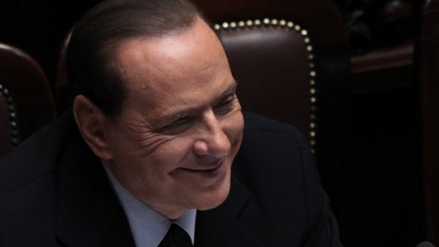 Italy's Prime Minister Silvio Berlusconi smiles during a debate at the Parliament in Rome