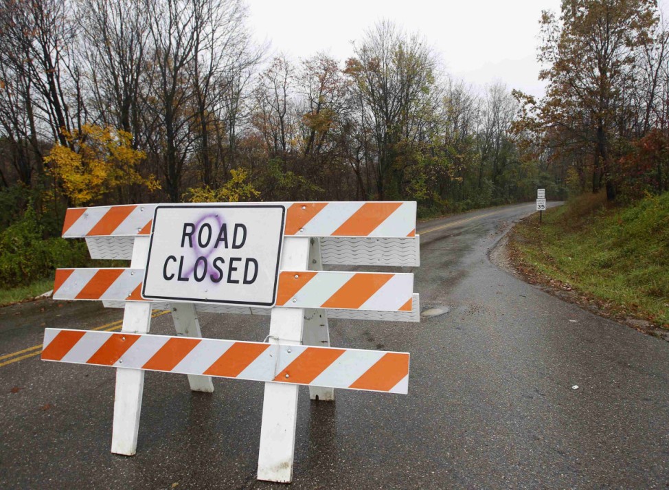 A sign blocks the entrance of a road leading to a property where exotic animals escaped in Zanesville