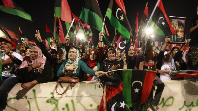 People celebrate at Martyrs' Square in Tripoli