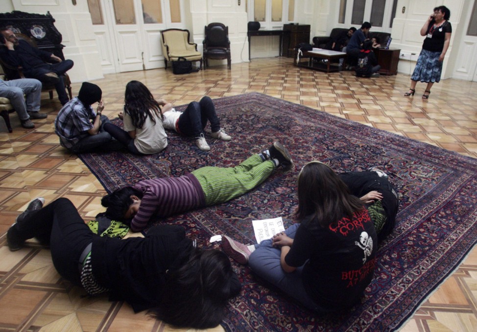 Students take a rest during their protest inside the Senate headquarters in Santiago