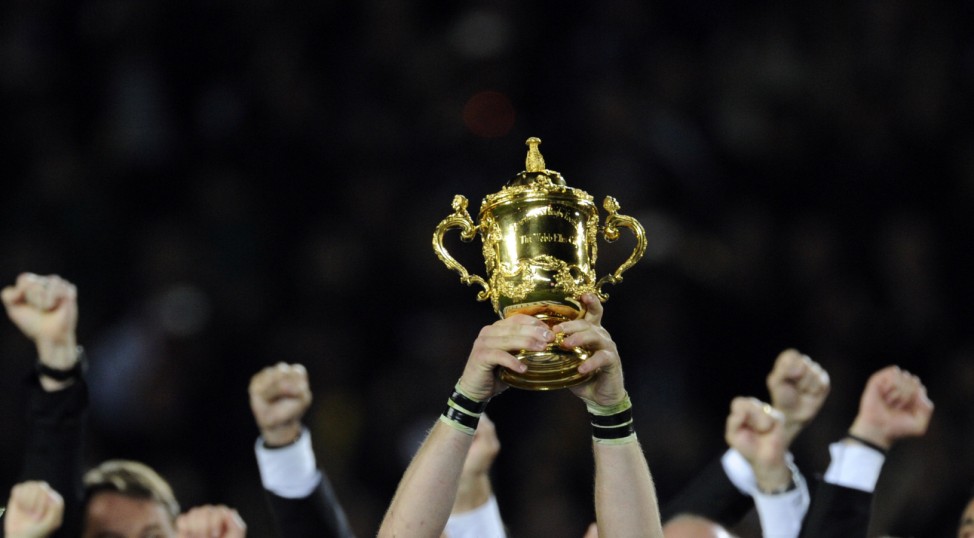 New Zealand All Blacks captain Richie McCaw holds up the Webb Ellis Cup in front of his team after they beat France to win the Rugby World Cup final at Eden Park in Auckland