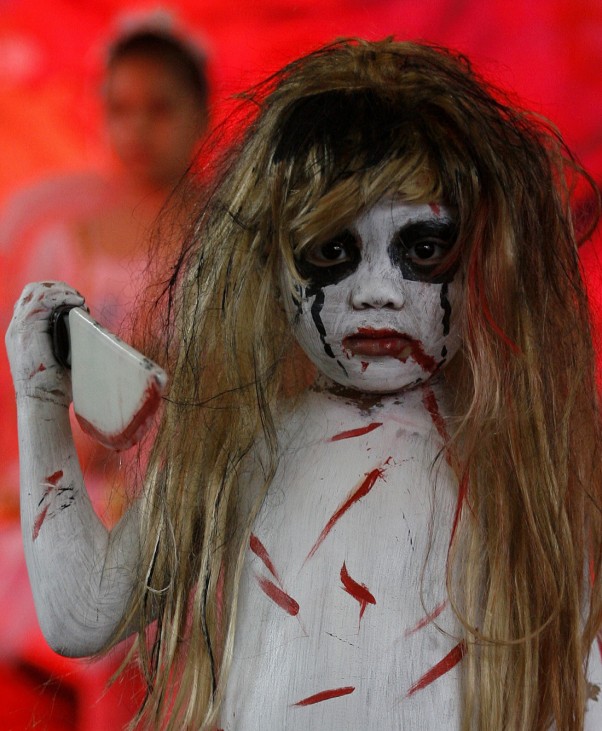 A girl models her costume at the 'Scaredy Cats and Dogs' Halloween fund-raising event at a mall in Quezon City