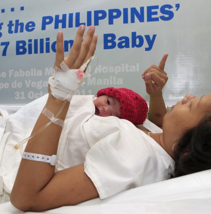 A newborn baby girl lies on the chest of her mother at a hospital in Manila