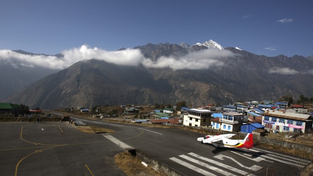 A small aircraft prepares to take off from Tenzing Hillary Airport in Lukla