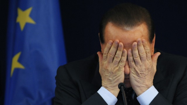 File photo of Italy's Prime Minister Berlusconi addressing a news conference at the end of a EU summit in Brussels