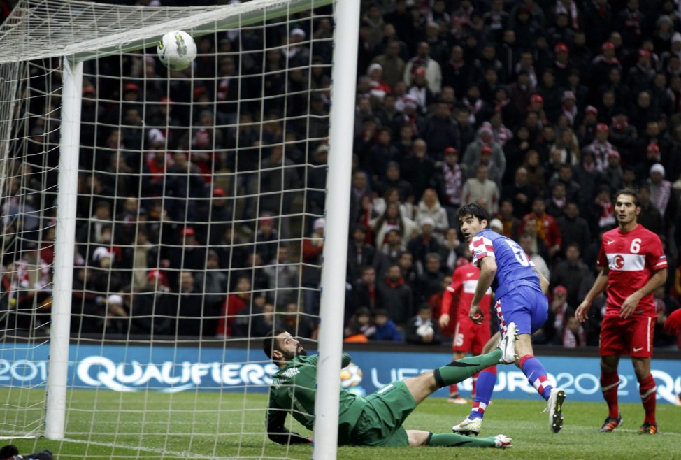 Croatia's Corluka scores against Turkey's goalkeeper Demirel during the first leg of their Euro 2012 play-off soccer match at Turk Telekom Arena in Istanbul