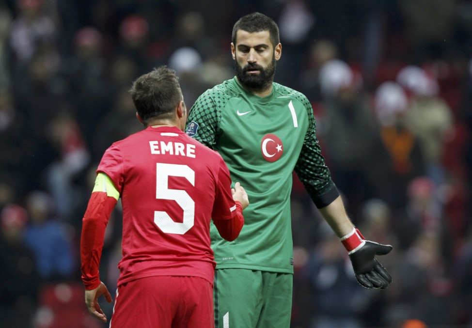 Turkey's Emre discuss with goalkeeper Demirel during the first leg of their Euro 2012 play-off soccer match against Croatia at Turk Telekom Arena in Istanbul