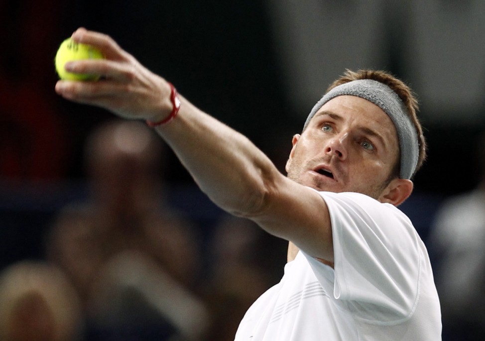 Mardy Fish of the U.S. serves to Argentina's Juan Monaco during the Paris Masters tennis tournament