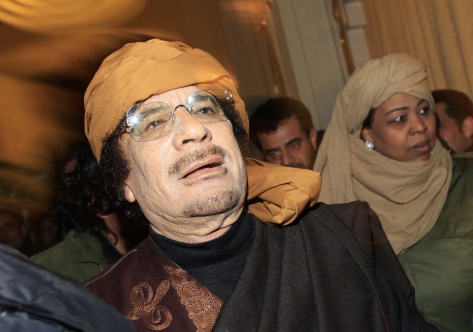 Libya's leader Muammar Gaddafi arrives to give television interviews at a hotel in Tripoli
