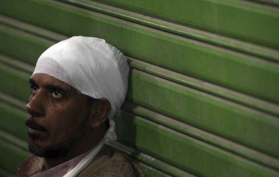 An protester wounded during clashes with Egyptian riot police rests at a field hospital near Tahrir Square