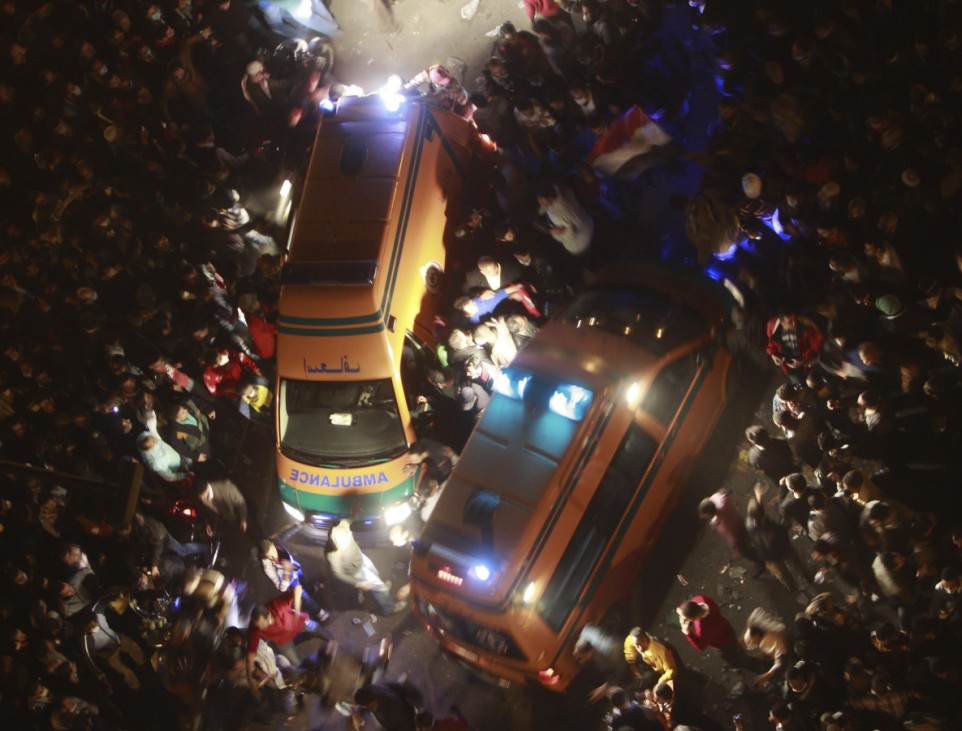 Protesters surround ambulances transporting injured protesters after clashes with the army and riot police at Tahrir Square