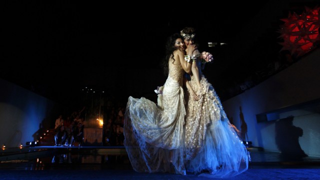 Models present creations of Argentine designer Carolina Abudele during a same-sex wedding dress fashion show in Buenos Aires