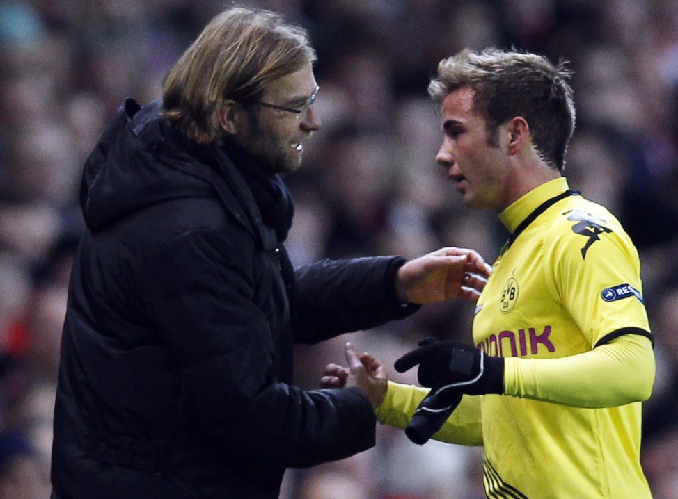 Borussia Dortmund's Mario Gotze shakes hands with team manager Jurgen Klopp as he is substituted during their Group F Champions League soccer match against Arsenal at the Emirates stadium in London