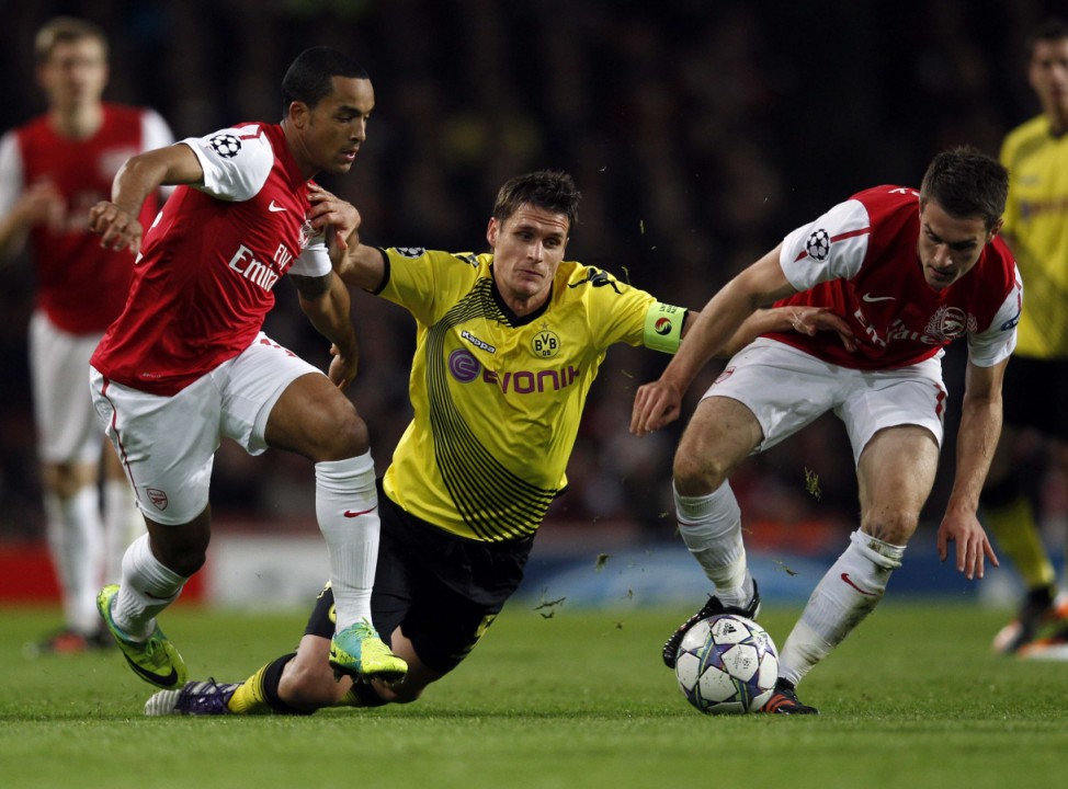 Arsenal's Walcott and Ramsey tackle Borussia Dortmund's  Kehl during their Champions League soccer match at the Emirates stadium in London
