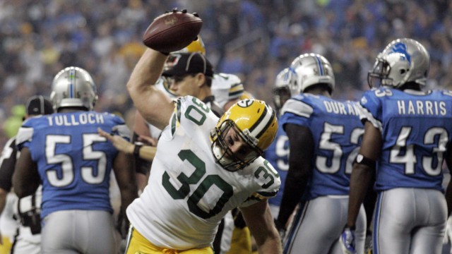 Green Bay Packers full back John Kuhn spikes the ball after scoring a touch down against the Detroit Lions during the second half of their NFL football game in Detroit