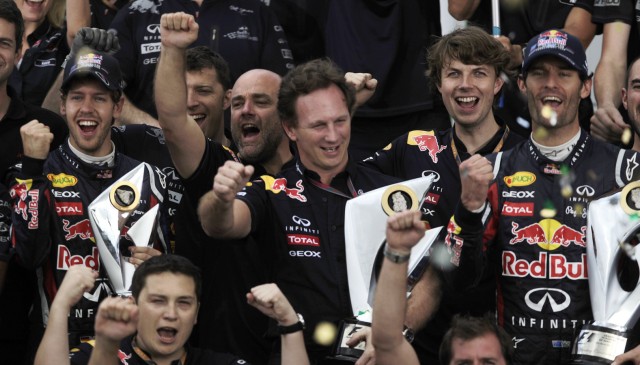 Red Bull Formula One World Champion Vettel and his teammate Webber of Australia celebrate with Red Bull Formula One team members after the Brazilian F1 Grand Prix at the Interlagos circuit in Sao Paulo