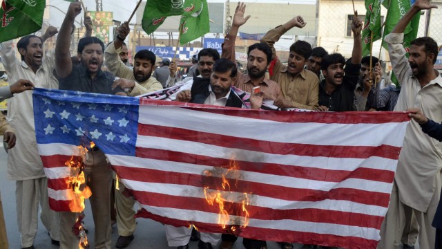 Afghanistan-Mission der USA: Anhänger der Pakistanischen Muslim-Liga (PML-N) verbrennen eine US-Flagge. Damit protestieren sie gegen den kürzlichen Angriff auf pakistanische Soldaten.