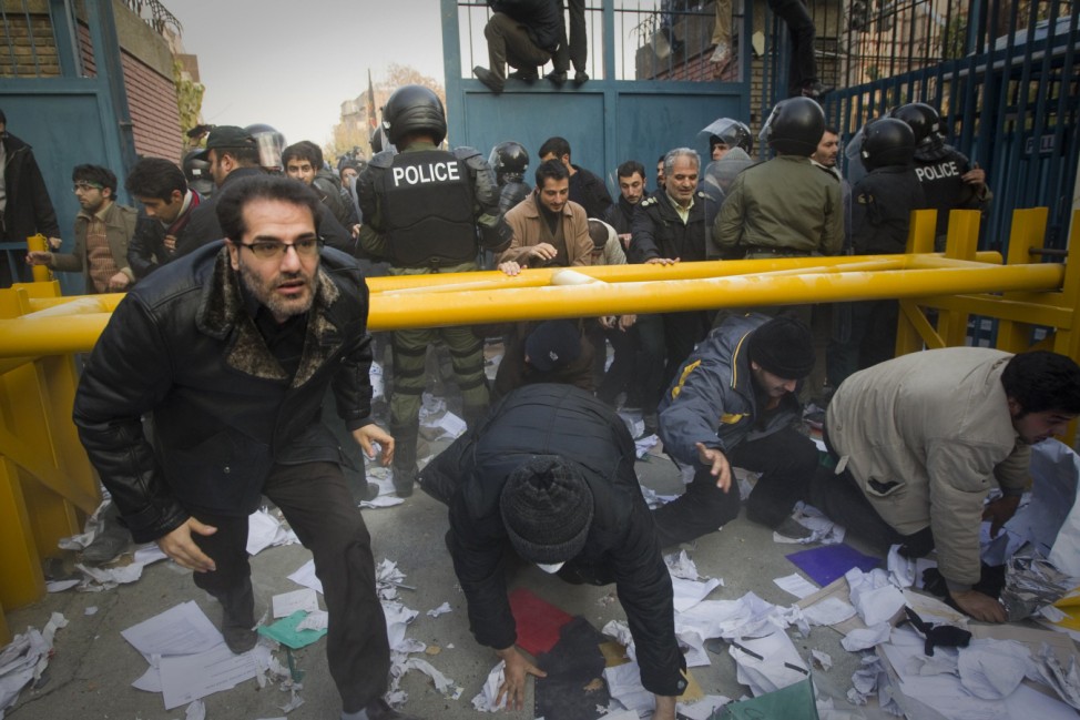 Protesters enter the gate of the British embassy in Tehran