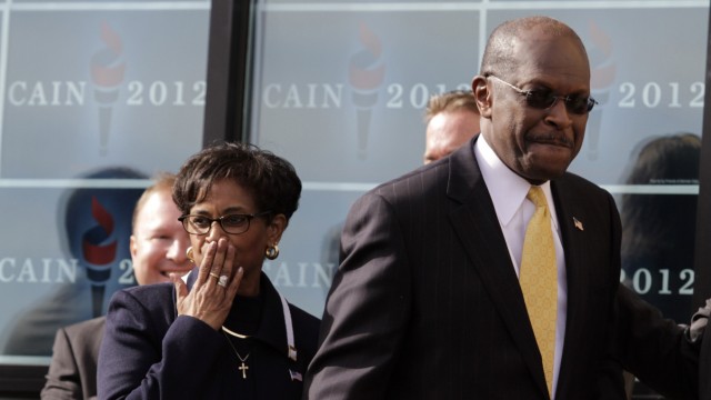 Herman Cain arrives with his wife Gloria at his side to announce that he is 'suspending' his Republican presidential campaign at his Georgia campaign headquarters in Atlanta