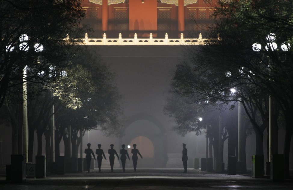 Paramilitary policemen practise drills inside the Forbidden City during a heavy haze and smog night in central Beijing